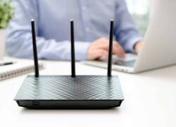 bigstock-Wireless-Router-And-Man-Using-211482115-scaled-1.jpg